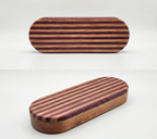 Two different pictures of the same oval-shaped object that is striped purple and cherry on top with a cherry bottom