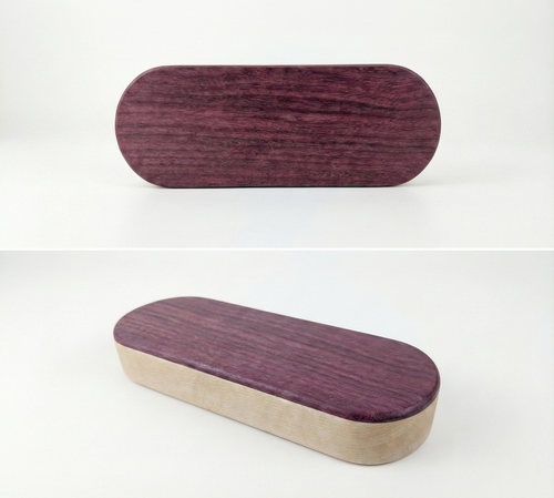 Oval-shaped wooden object with purple heart wood for the top and maple wood for the bottom. Two images stacked on top of each other one in flat lay orientation and the other in a diagonal orientation.